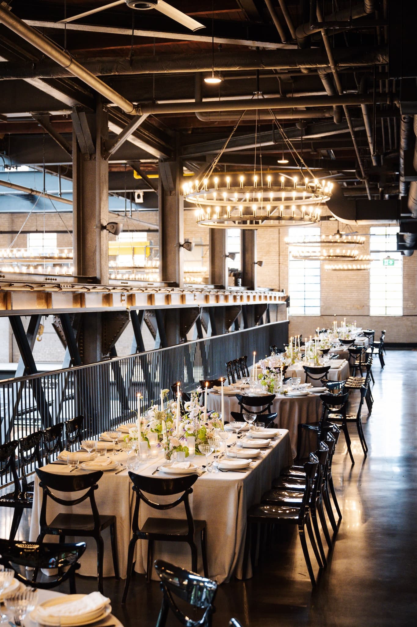 View of rectangular tables set for a seated dinner