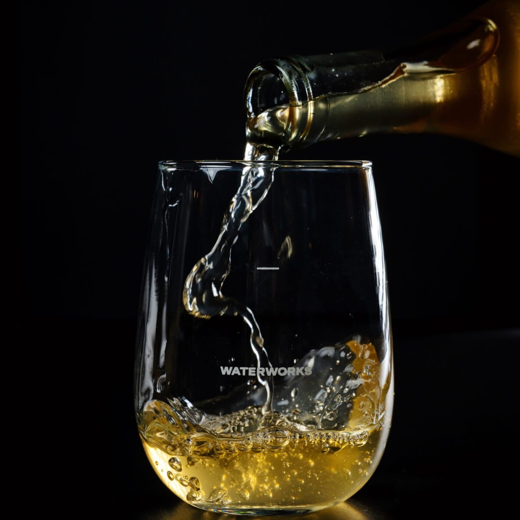 White wine being poured into a glass